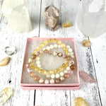 Stacked Citrine, Agate, and Moonstone bracelets representing new beginnings
